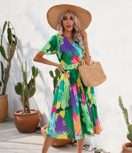Detail of bohemian leaf print dress with deep V-neck and ruffled sleeves for summer