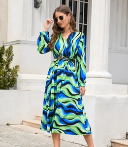Detail of V-neck long sleeve midi dress with blue wave print and gold buckle belt