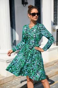 Detail of green and blue leopard print dress with V-neck, buttons, and waist tie