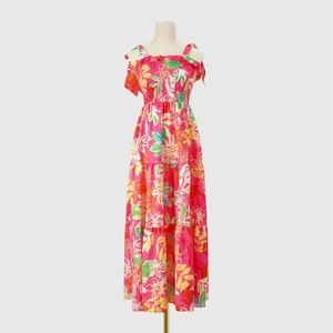 Detail view of the smocked bodice and tropical leaf print on this pink summer dress
