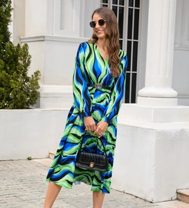 Detailed close-up of abstract wavy print fabric and waist belt on a V-neck long-sleeve dress