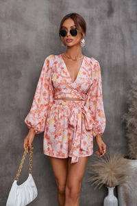 Detail of floral V-neck long sleeve crop top and high waist belted shorts in pink tones