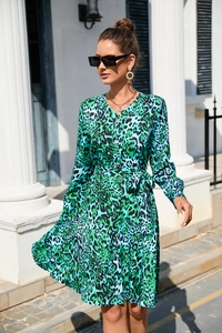 Detail of green and blue leopard print dress featuring V-neck and waist tie design