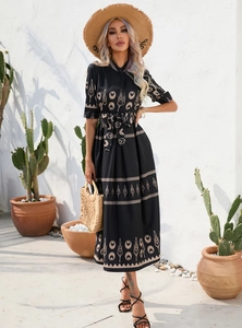 Close-up of bohemian floral print and waist tie detail on a black summer midi dress