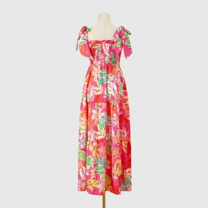 Detail of pink floral maxi dress with smocked bodice and layered tiered skirt style
