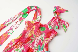 Detail of tropical floral print smocked top with adjustable wide shoulder tie ribbons