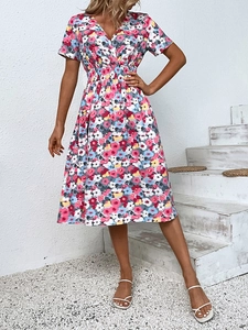 Detail of V-neckline and elastic high waist on colorful floral summer mini dress