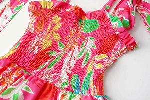 Close-up of tropical leaf print dress with elastic smocked bodice and tie straps