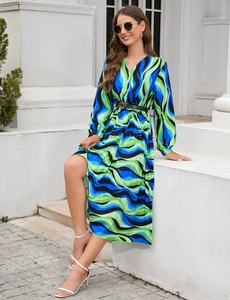 Detail of V-neck long sleeve dress with abstract wave print and black belted waist