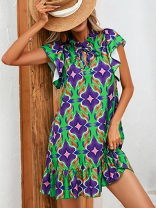 Detail view of summer floral dress showing vibrant ruffles and light woven fabric texture