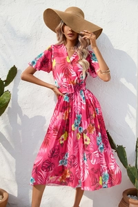 Detail of V-neck wrap dress with tropical floral print and matching waist belt