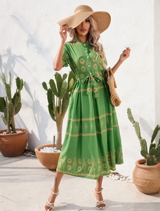 Detail of summer dress featuring green ethnic print, small stand collar and matching belt