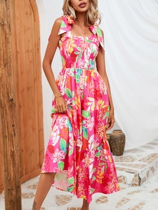 Detail of pink floral summer dress featuring shoulder ties and ruffled elastic bodice