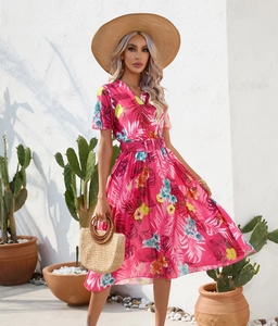 Close-up of tropical floral pleated dress with V-neck, short sleeves and matching belt
