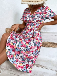 Detail of floral V-neck dress with elastic waist and vibrant summer flower prints