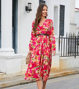 Detail of V-neck printed dress in magenta with abstract patterns and a black waist belt