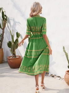Back view of green long dress with gold tulip prints and matching waist belt