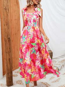 Detail of pink floral dress with smocked bodice and adjustable shoulder ribbon ties