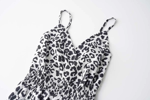 Detail view of the smocked waist and V-neckline on the leopard print slip dress