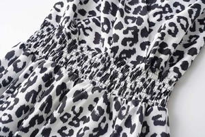 Close-up of leopard print fabric with elastic smocked waist detail on a summer dress