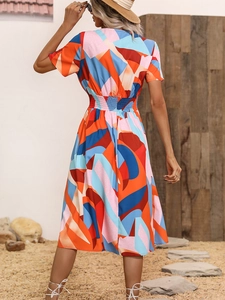 Back view of a summer dress with abstract geometric floral print and elastic waist