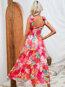 Detail of smocked back and tiered pink tropical floral maxi dress with bow straps