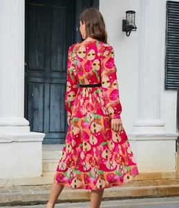 Detail view of the back of long sleeve printed midi dress with abstract floral patterns