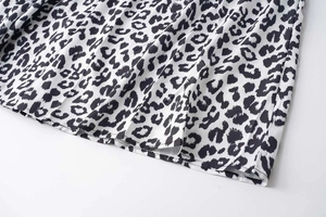 Detailed close-up of summer leopard print dress fabric showing black and white patterns