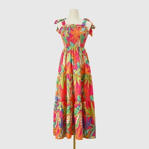 Detail of tropical leaf print dress featuring elastic smocked bodice and tie-up straps