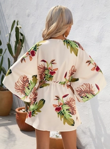 Detailed back view of a summer leaf print dress featuring wide sleeves and elastic waist