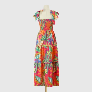 Detail of tropical leaf print dress with bow tie straps and tiered maxi skirt