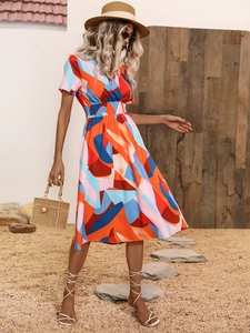 Detail of summer V-neck mini dress with bold geometric floral print and elastic waist