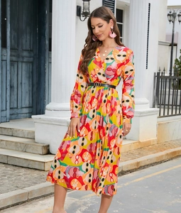 Detail of V-neck long sleeve dress with vibrant abstract print and black ring belt