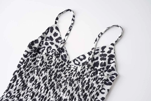 Detail of leopard print dress featuring elastic smocked fabric and adjustable straps