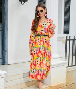 Detailed view of the vibrant V-neck pleated maxi dress with abstract floral patterns