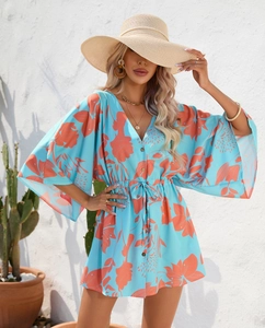 Detailed close-up of summer dress featuring floral print, V-neckline, and drawstring waist
