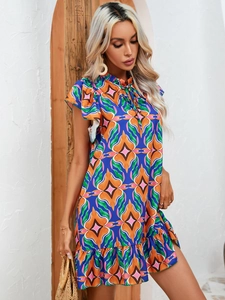 Detail of summer mini dress with abstract geometric print and ruffled cap sleeves
