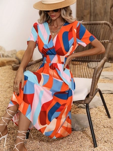 Detail of V-neck summer dress with colorful geometric floral print and elastic waist