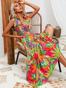 Detail of bohemian floral maxi dress featuring colorful tropical leaf print and smocked bodice