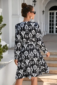 Detailed back view of a long-sleeved dress with black and white ikat geometric print