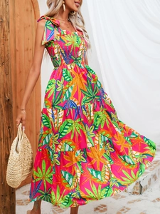 Detail of tropical palm leaf print on a bohemian summer maxi dress with tiered skirt
