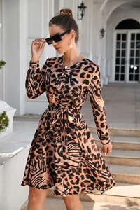 Detailed view of leopard print long-sleeve dress with waist belt and button closure