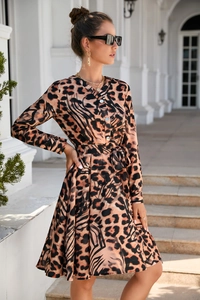 Detail of leopard print long sleeve dress with button-up V-neck and matching waist belt