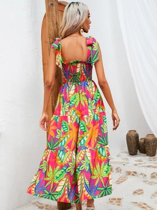 Detail of tropical leaf print dress featuring back smocking and layered ruffle skirt