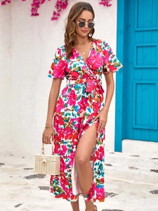 Detail of tropical floral print wrap dress with side slit and waist tie for summer