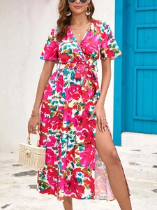 Detail of high side slit and vibrant floral pattern on wrap summer midi dress