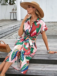 Close-up of tropical floral print shirt dress with button-down and waist tie detail