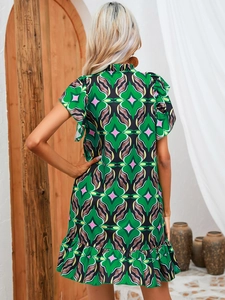 Detailed back view of a green floral summer dress with ruffled hem and boho print
