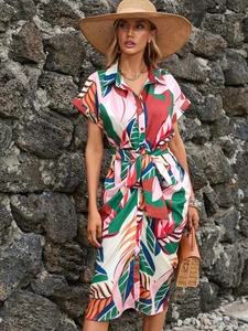 Detail of tropical leaf print shirt dress with button-down front and waist belt