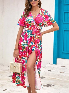 Detail of summer floral maxi dress featuring high slit and vibrant digital printing